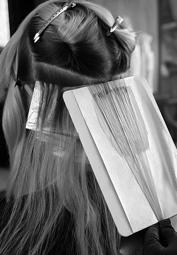 Hair foil highlights color service application at The Crown Hair Studio Orlando