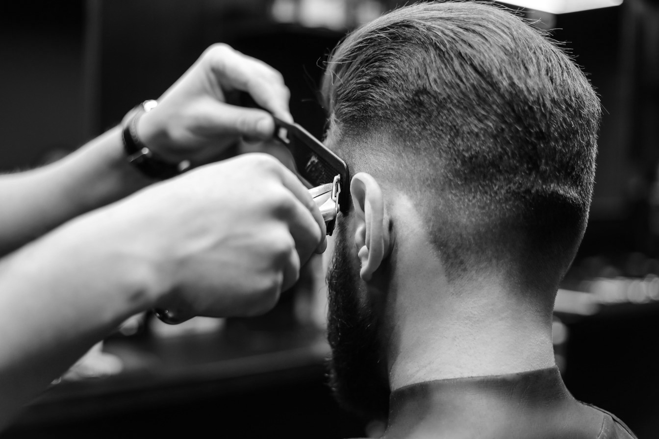 Stylist precision clipper fade on men's haircut at The Crown Hair Studio Orlando
